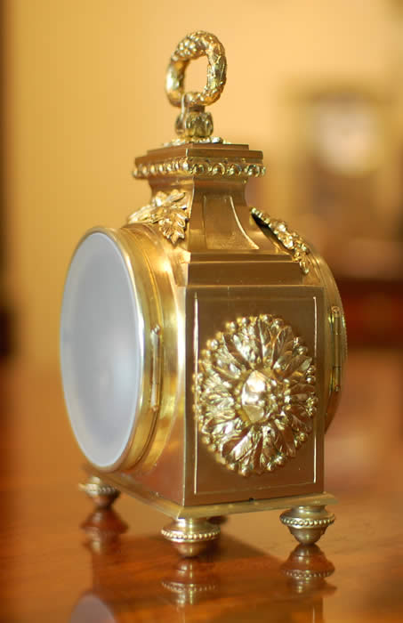 A fine Pendule d'officier with 8 day duration movement with a jeweled lever escapement . The convex enamelled dial showing black Arabic numerals with minutes to the outer edge and gilt quarter markers , decorated with finely chased , pierced and gilded hands . The case having floral and ribbon gilt mounts in the classic 'Pagoda' shape . The drop handle with vine leaves and grapes . Standing on four turned feet . Circa 1890. 