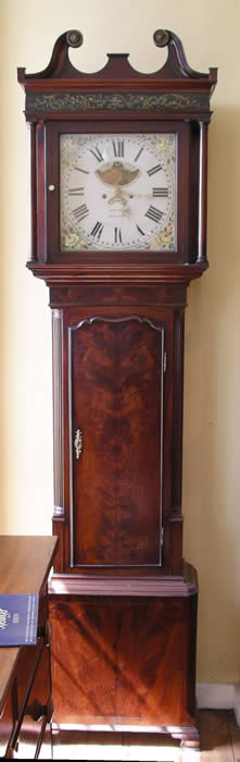 A substantial and well proportioned highly figured mahogany longcase with a painted dial showing phases of the moon below the twelve ,8 day duration striking the hours on a bell. The case has good detail with canted corners to the base , bracket feet , a book matched trunk door with shaped edge , a cushion shaped decorated panel below the swan neck pediment . John Kent of Salford , Manchester was working from 1804 and is listed in Clock and Watchmakers of the World , book by Loomes . fully restored and sold with a one year guarantee 