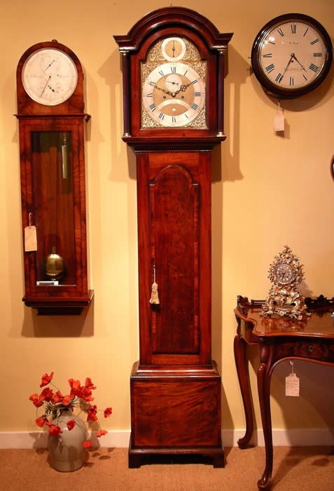 clock photo , Longcase clock by Northcote and son Plymouth , Full Brass dial with Strike silent in an Arched Mahogany case 