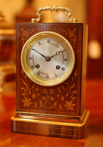 A very fine marquetry inlaid rosewood mantel clock of superb proportions, very good colour and patina with small lenticel below the decorative handle to view the original silk suspension escapement , The 3 inch dial is slivered and has an engine turned decoration to the center with Roman numerals for the chapter ring .Boxwood stringing to all sides of the case and floral marquetry inlays . A fine French 8 day movement striking on a Bell , polished blue steel Breguet Hands the back of the movement has a name stamp of Delolme and a Henry Delolme is recorded making and retailing clocks , watches and chronometers at 48 Rathbone Place , Oxford Street , London in the early 19th Century and exhibited in the 1851 Great exhibition . Standing 24cms small ! (with Handle raised) . Circa 1840-50