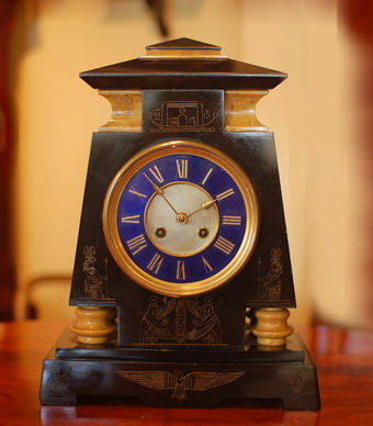 This fine and unique clock has to be seen to fully appreciate the proportions and its stature . The clock is made from Sienna Marble and Deep black Belgium Slate , the case has been hand engraved with ancient Egyption symbols . The 8 day , bell striking hourly and half hourly movement , with an unusual indigo blue dial ground mounted with gilded Roman numerals and simple Gilded spade hands . A cast bezel surround with bevelled glass . Stamped to the backplate .Circa 1870- 1890 . With the Suez Canal opening in 1869 and the interest in Britian and France of Egyption art , this type of clock was hand made to supply a demand and 'fashion' which lasted until the First World War and then following the discovery of Tutankhamun's tomb in 1922 . Shown Unrestored 