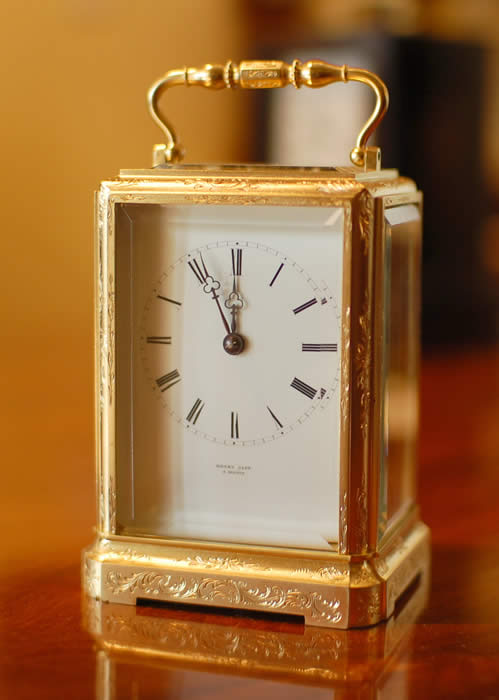 A good early carriage clock by Henry Capt of Geneve who was working circa 1840 . This is a superb example with the original , early lever platform . The clock is engraved on the back plate with the name in script along the base . The large top bevelled glass below the very ornate handle shows the escapement . A fine 8 day movement - bell striking . The case is 'one piece' design with superb hand engraving and gilding of good colour , all bevelled white glass polished inside and out . The dial showing Roman numerals and the makers name below the six with the original 'Trefoil' hands . Please view the large images by clicking through the photos . 12 month RTB Guarantee