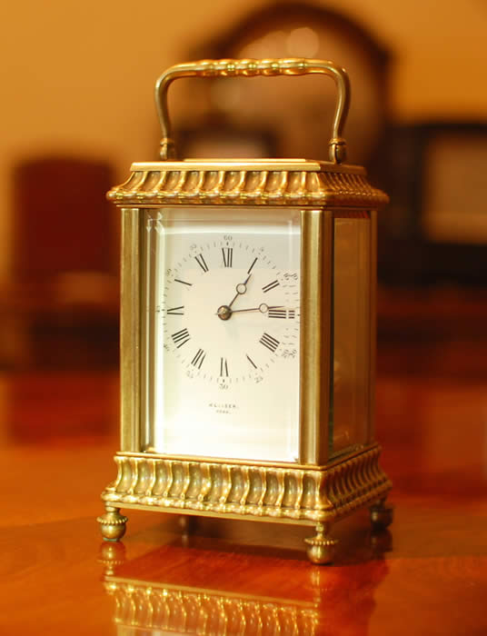 A superb and unusual carriage clock in a cast gorge 'gadrooned' style case with white enamel dial signed by Kleiser of York , Gong striking for the hours   