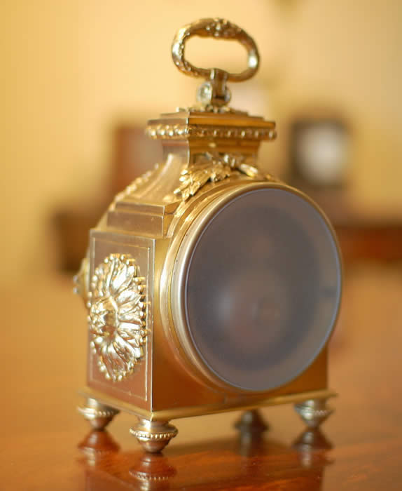 A fine Pendule d'officier with 8 day duration movement with a jeweled lever escapement . The convex enamelled dial showing black Arabic numerals with minutes to the outer edge and gilt quarter markers , decorated with finely chased , pierced and gilded hands . The case having floral and ribbon gilt mounts in the classic 'Pagoda' shape . The drop handle with vine leaves and grapes . Standing on four turned feet . Circa 1890. 