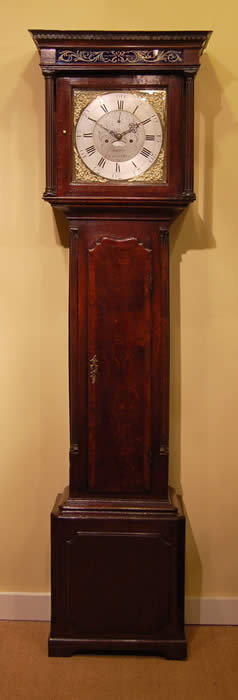 A fine oak Lancashire Longcase clock of good proportions with full 12 inch brass dial showing silvered Chapter ring , Calendar and dial center with gilt spandrels to the dial corners . The hood with columns and a dentil moulding , crossbanding around the door and reverse painted glass known as Verre eglomise above . The trunk in Oak with mahogany crossbanding , quarter columns and panelled base .Thomas Ashton of Macclesfield was working from 1760-95 and is listed in Clock and Watchmakers of the World , book by G.H.Ballie . 