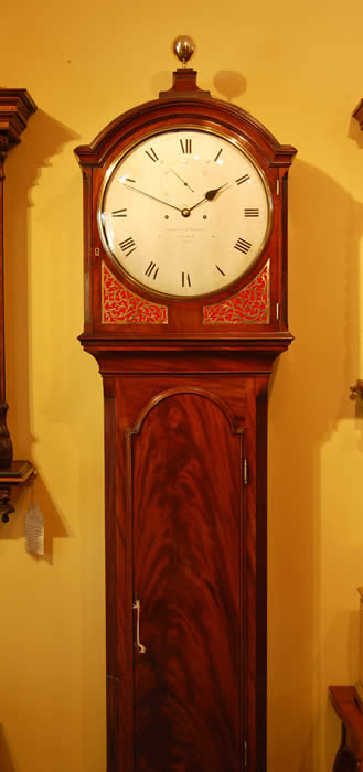 This is a beautiful longcase clock , we do not normally describe our clocks so passionately but this is an object of beauty . The overall proportions of the clock are perfect , the balance of the silvered dial and polished quarter sound frets , the simple yet elegant hands , the mellowed mahogany case , the tuned bell strike for the hours sounding through silk backed 'fishscale' frets . The movement is deadbeat with mainainting power ,8 day of extremely high quality throughout with very substantial plates . The design is classic regency with the unfussy round dial , hand engraved with the makers names Gravell and Tolkien London and numbered . Tolkien is the great Grandfather of the author J.R.R. Tolkien (The Hobbit , Lord of the rings ) Gravell and Tolkien were the successors to the late Eardley Norton . 