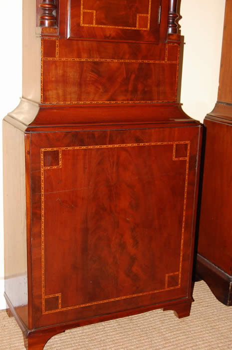 This is very decorative 'Rocking Ship' Longcase clock of 8day duration with a pleasant bell strike for the hour . This clock has in the arch of the dial a Ship that Rocks from side to side with each tick of the clock , this feature was popular when the clock was made as there were no moving images elsewhere to be seen .The dial also includes a calendar and seconds hand with all hands being the original Brass fret cut and punch decorated . The cabinet is of highly figured mahogany with box-line inlays , turned columns to both the hood and to the trunk . Standing on small bracket feet . David Bevan of Hirwain is listed in the Slaters Commercial directory of 1858 , this clock dates to around the 1840-50's . 