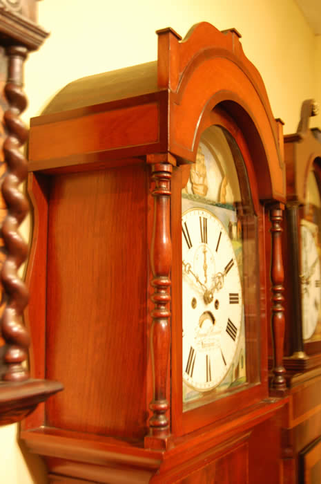 This is very decorative 'Rocking Ship' Longcase clock of 8day duration with a pleasant bell strike for the hour . This clock has in the arch of the dial a Ship that Rocks from side to side with each tick of the clock , this feature was popular when the clock was made as there were no moving images elsewhere to be seen .The dial also includes a calendar and seconds hand with all hands being the original Brass fret cut and punch decorated . The cabinet is of highly figured mahogany with box-line inlays , turned columns to both the hood and to the trunk . Standing on small bracket feet . David Bevan of Hirwain is listed in the Slaters Commercial directory of 1858 , this clock dates to around the 1840-50's . 