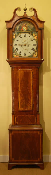 A detailed and fine , flame mahogany longcase clock with Walnut and Rosewood crossbanding , ebony line inlays with Burr Elm panels . The hood has full fluted columns with Brass capitals , the crossbanded and edged base has single plinth with Bracket feet . A very good example of Dundee cabinet making from the early Victorian period . The Painted dial is in near perfect condition and has a Lady playing a Harp to the Arch , the paintings are on Gold and silver leaf so they reflect back and light the dial . The movement is of good quality  and strikes the Hour on a bell and runs for a week on a single wind . W.Young of Dundee is Listed in 'Old Scottish Clockmakers' by John Smith - working from 1805-43 in High street ,Dundee . 