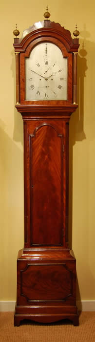 A fine , well proportioned , flame Mahogany , London Strike silent Longcase by Heywood of King Street , Covent Garden . The Case with canted fluted columns and Brass reeding either side of the Long arched trunk door , the base with panel and classic London double plinth , the Hood with simple yet elegant fret with fluted pillars and brass ball finials , the restrained silvered dial engraved with the makers name - Heywood King street Covent Garden , London , the Large five knopped pillar movement with Brass cased weights and pendulum Bob , Striking the Hours on a Bell or silent at will . Listed in Loomes-Watch and clockmakers of the World , working in 1811 and he most probably worked 10 years before and after that single date , Standing 238cms Tall 