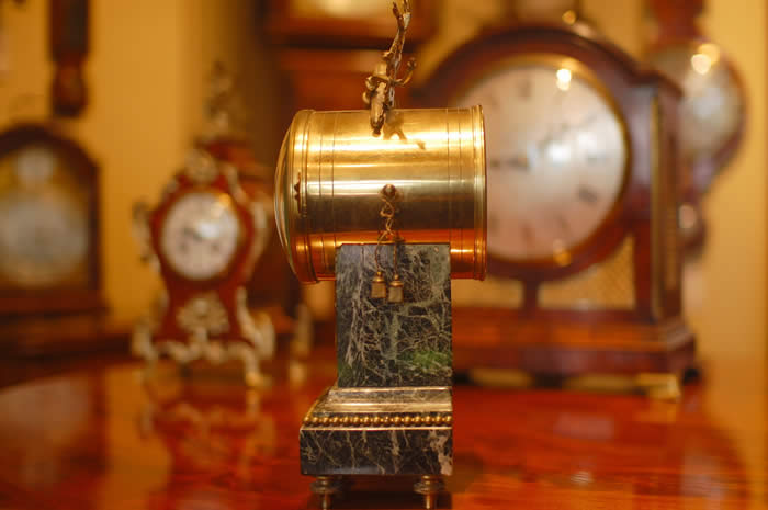 A French mantel clock on a Marble base which has Ormalu decorations , the clock is of 8 day duration , striking hourly and half hourly on a bell with a white convex enamel dial showing arabic Numerals and garlands of flowers with finely pierced Gilded Brass Hands and a cast brass bezel surround . A small clock which would fit most mantels or perhaps even a 'Boudoir' ! . Made in Paris around 1890