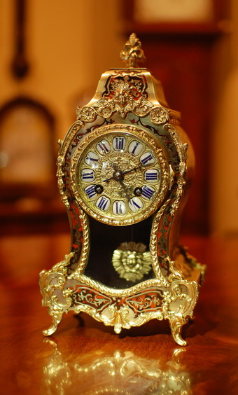 A French 'Boulle' mantel clock of 8 day duration , striking hourly and half hourly on a gong .The twelve section cartouch dial showing Roman Numerals polished blued steel Hands and a Cast brass decorative bezel surround . The case is typical of Boulle work ,after Andre-Charles Boulle and has a good level of detail with the sides also being fully decorated , standing on 'C' scroll bracket feet a glazed aperture to view the sun-burst pendulum with a finial to finish . Made in Paris around 1880-90 Stamped and numbered. It is worth remembering that all our clocks have had a full dismantle / overhaul unlike many others for sale online and carry a full 12 month Guarantee in writing , which adds to the value and longevity of this fine clock .