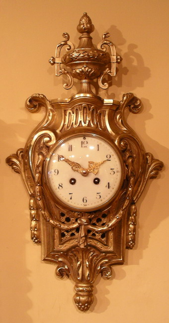 A fine gilt bronze decorative French wall clock with convex enamelled dial showing Arabic numerals , finely pierced hands  and two winding holes with one for the time and the other for the strike , this clock strikes the hour an a bell and half hour with a single strike . Made by Japy Freres of Paris - Circa 1890-1900 . 