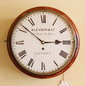 A 12" cast bezel , British fusee wall clock in a mellow , mahogany case.