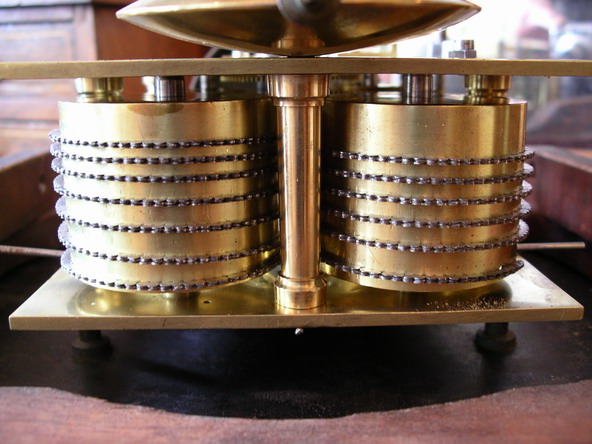 A rare 12" British double fusee wall clock in a mellow , mahogany case. The movement is very substantial with a five pillar ,Chain fusee and square plates